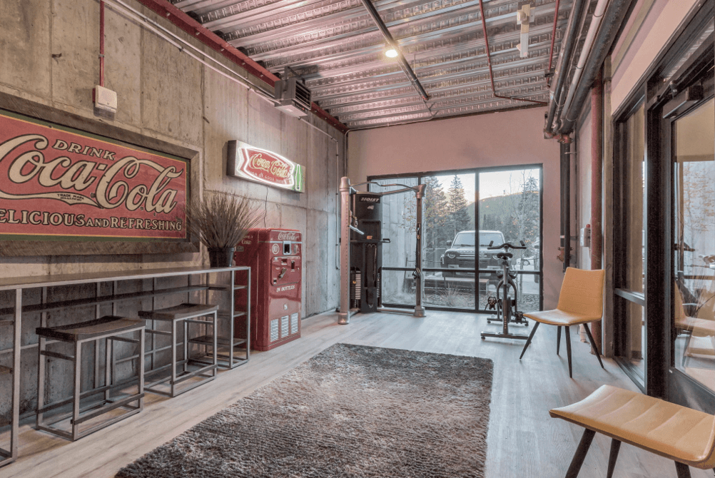 The club bar area with stools, a vintage Coca-Cola sign and a red vending machine